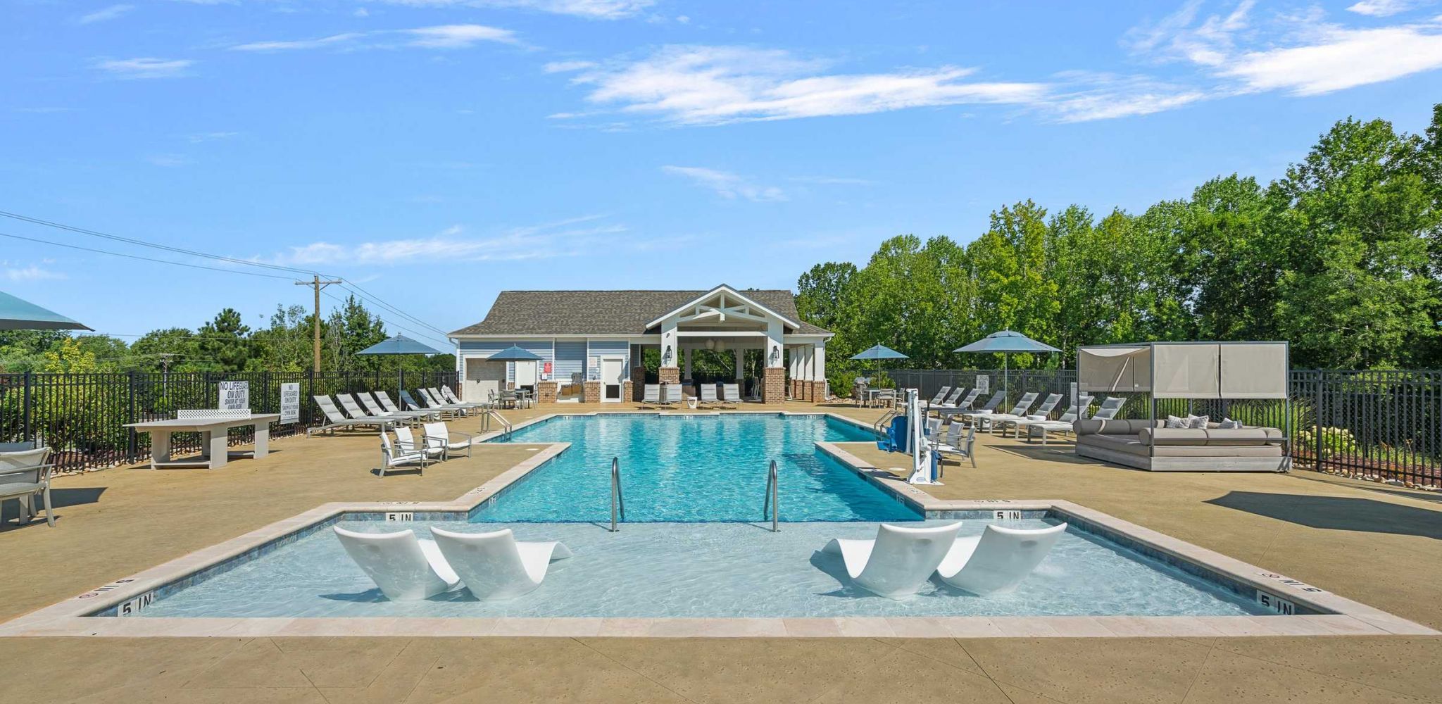 Hawthorne Palmetto luxury outdoor pool with in-pool lounge chairs and surrounding seating