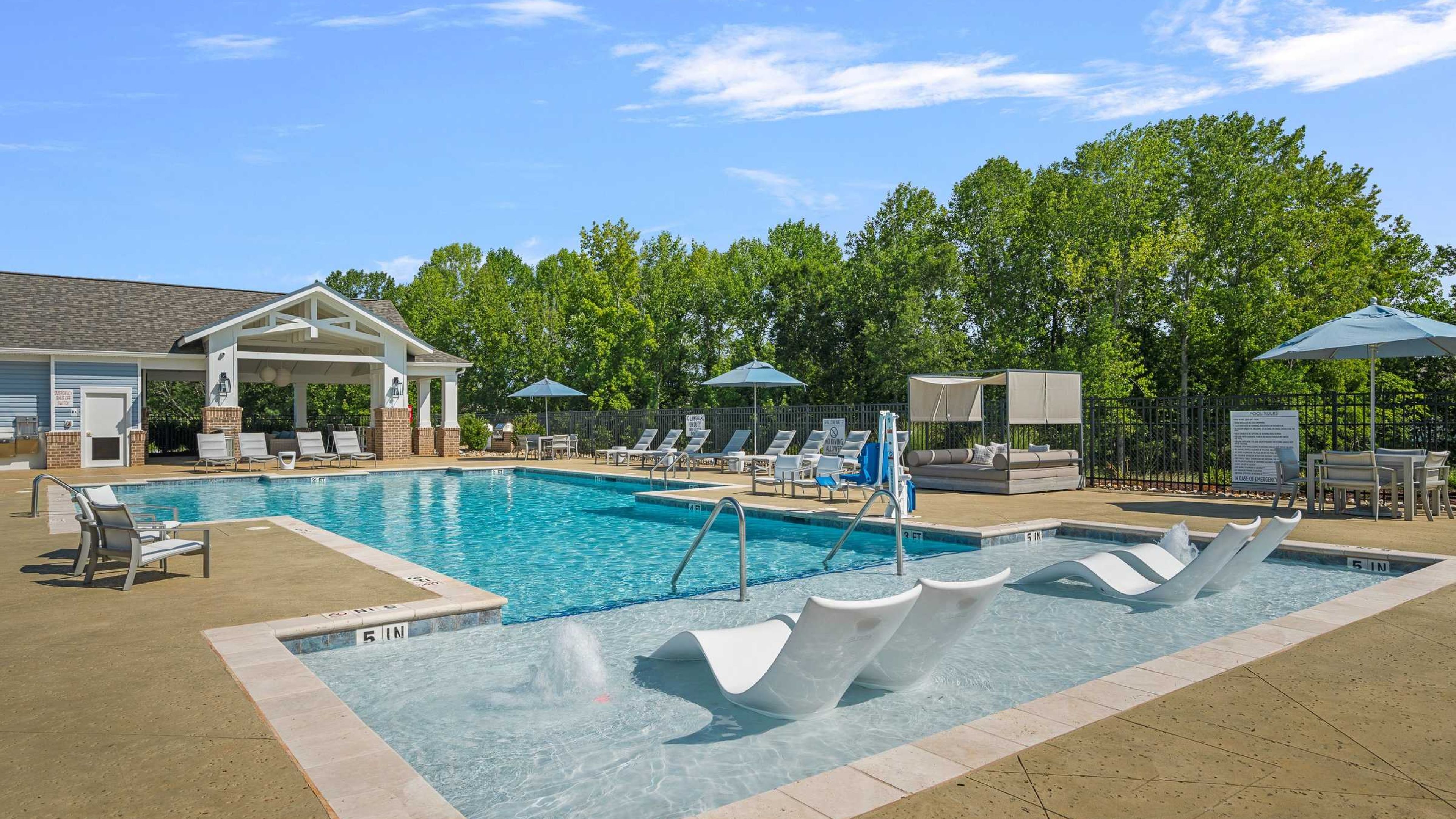 Hawthorne Palmetto luxury outdoor pool with in-pool lounge chairs and surrounding seating